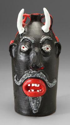 Appraisal: Brown Pottery double devil jug one side with black-painted devil