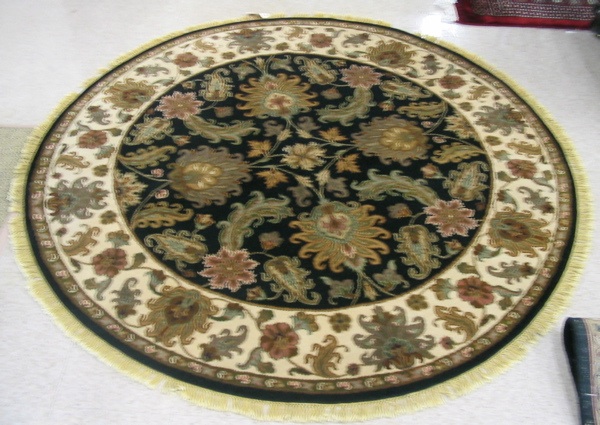 Appraisal: A ROUND ORIENTAL ACCENT RUG Indo-Persian floral arabesque decoration on