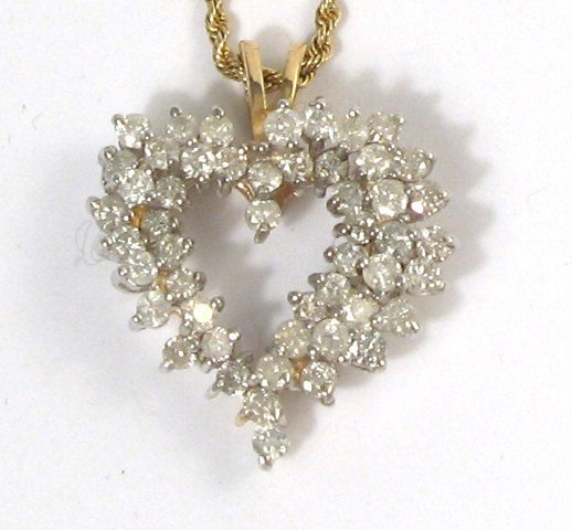 Appraisal: DIAMOND AND YELLOW GOLD PENDANT NECKLACE the heart shaped pendant