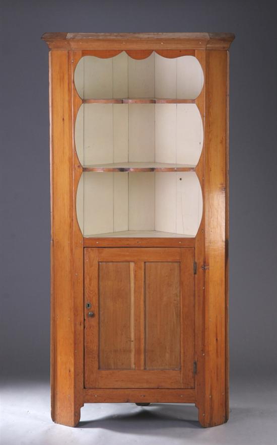 Appraisal: AMERICAN COUNTRY PINE CORNER CUPBOARD early th century Canted-corner case