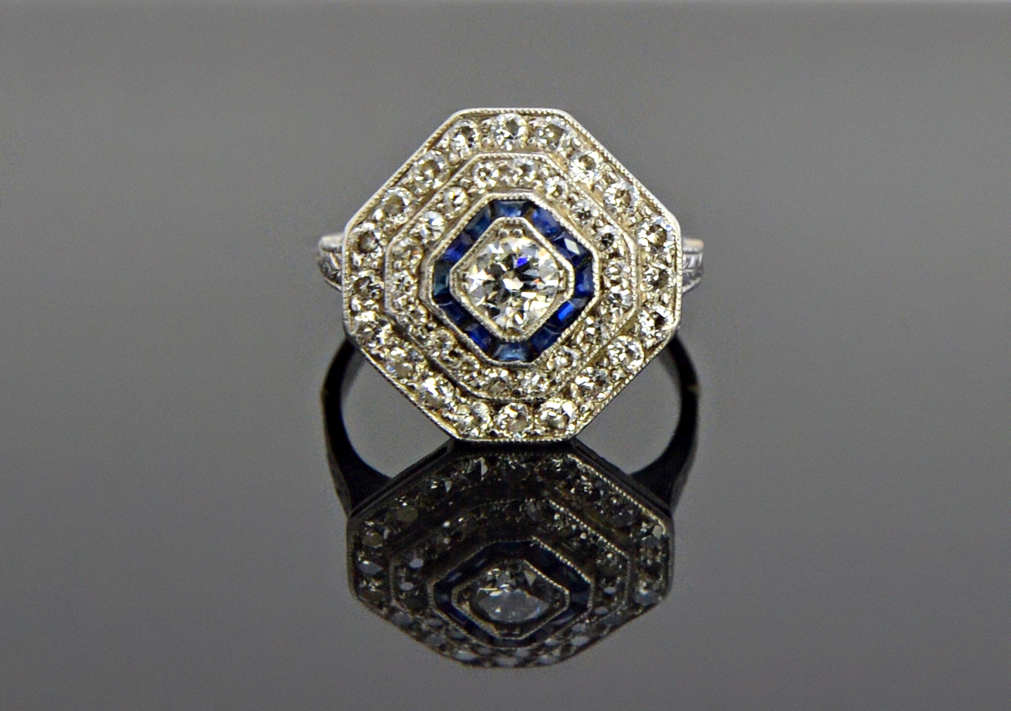 Appraisal: A diamond and blue gem set octagonal shaped cluster ring