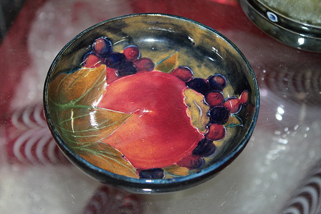 Appraisal: A MOORCROFT PIN DISH with pomegranate decoration cm diameter