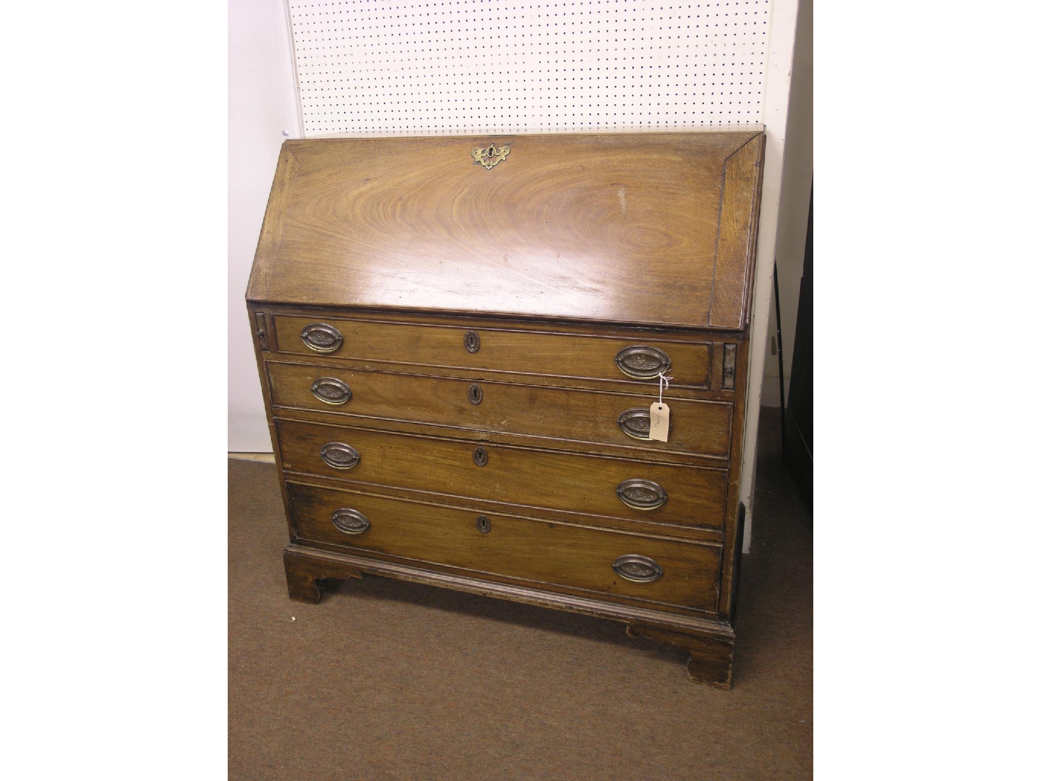 Appraisal: A George III mahogany bureau fall-front enclosing an arrangement of