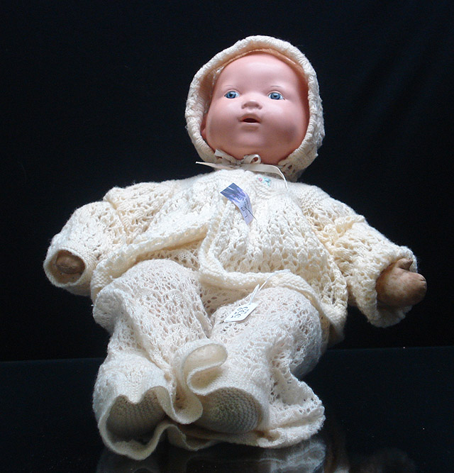 Appraisal: A baby doll with celluloid head and fixed grey glass