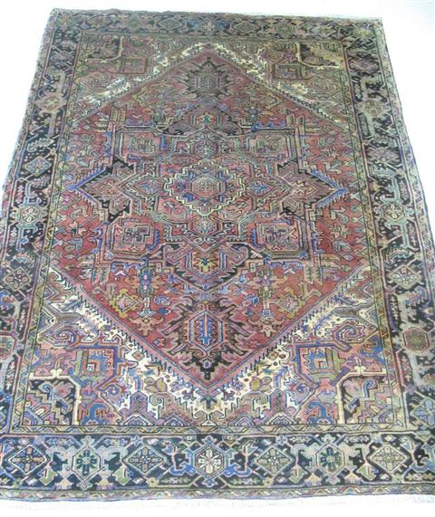 Appraisal: HERIZ RUG with central medallion within a foliate border h