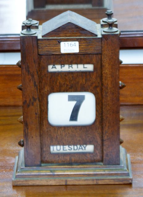 Appraisal: A Victorian walnut desk calendar