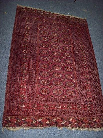 Appraisal: A Bokhara rug of crimson ground the central field of