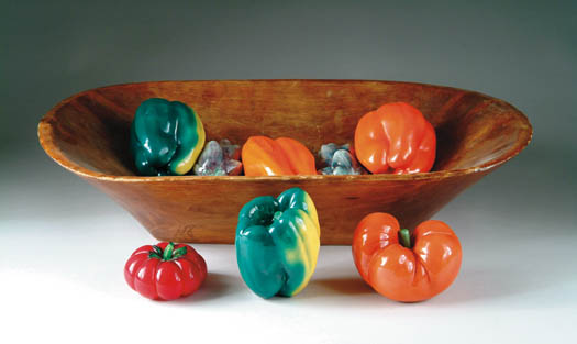 Appraisal: WOOD TRENCHER WITH POTTERY VEGETABLES The vegetables include two orange