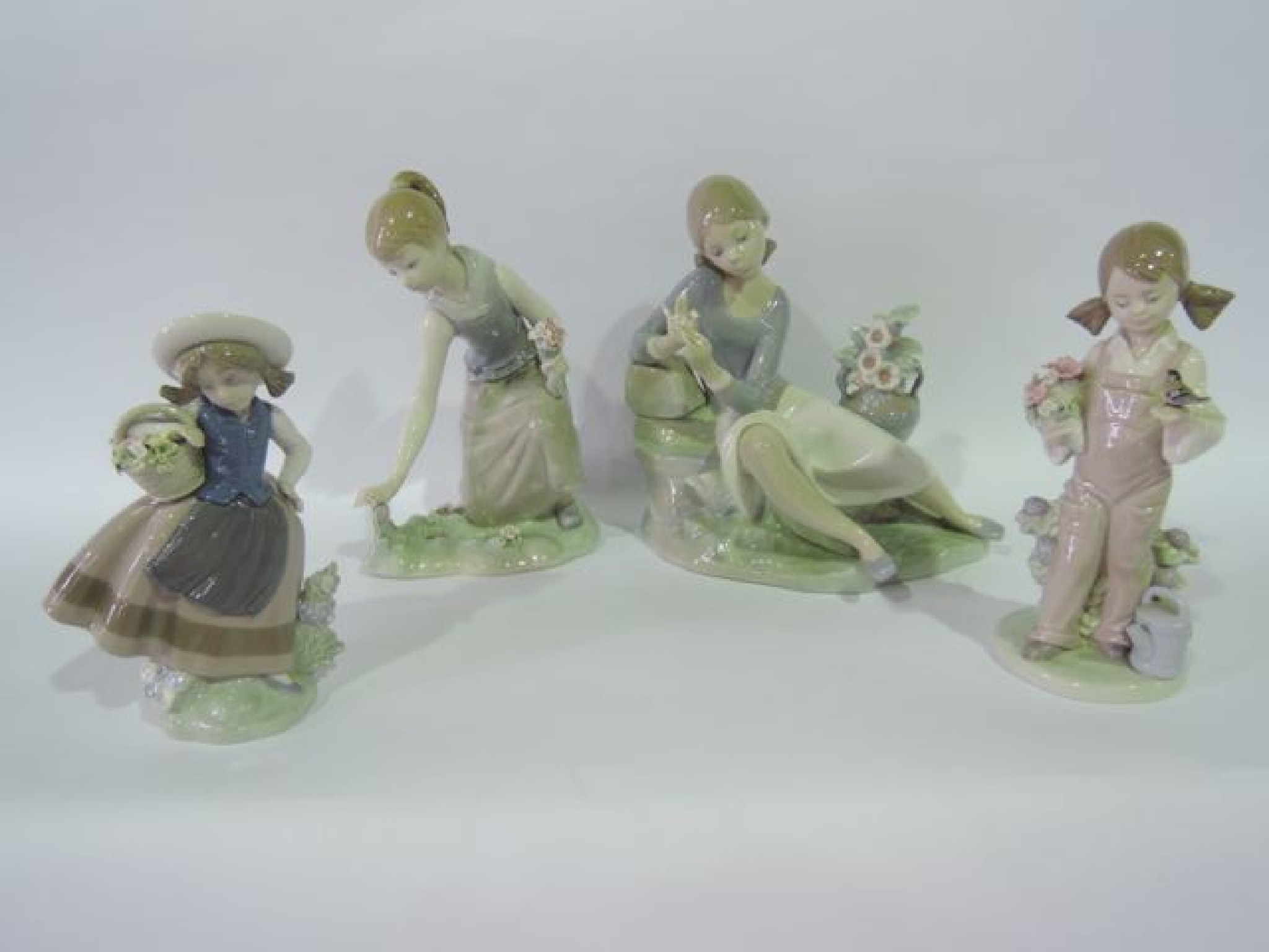 Appraisal: A collection of four Lladro figure groups comprising a figure