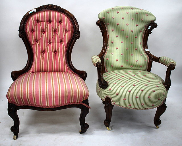 Appraisal: A VICTORIAN WALNUT FRAME ARMCHAIR with shaped back and carved