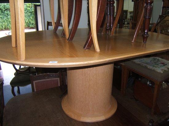 Appraisal: A modern oak circular extending dining table on drum support