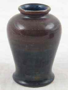 Appraisal: Moorcroft A small vase dark brown shading to black Ht