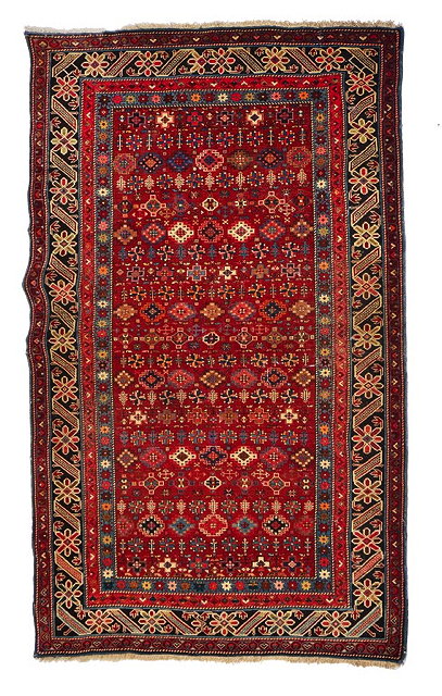 Appraisal: A CAUCASIAN CHICHI RED GROUND RUG the central panel with