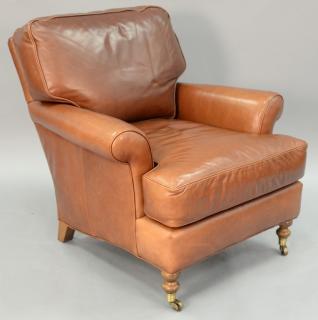 Appraisal: Brown leather upholstered easy chair Brown leather upholstered easy chair