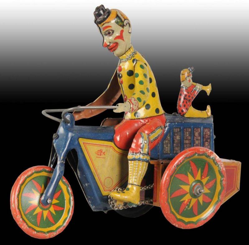 Appraisal: German Fisher Tin Wind-Up Clown Motorcycle Toy Description Marked Germany