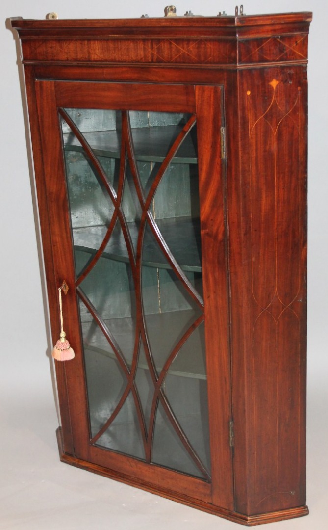 Appraisal: A thC mahogany and boxwood strung hanging corner cupboard with