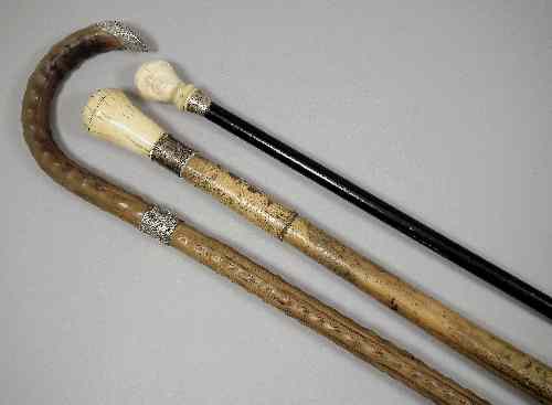 Appraisal: An ebony cane with ivory cane handle carved as a