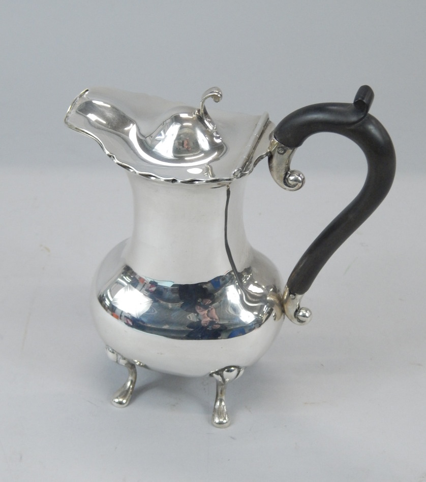 Appraisal: A small Edwardian hot water jug with a hinged lid