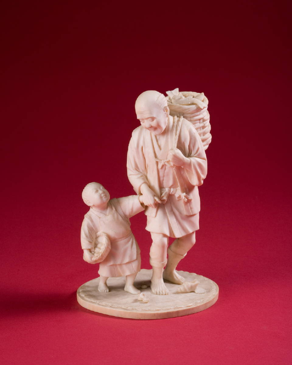 Appraisal: JAPANESE CARVED IVORY FIGURE OF A MAN AND HIS SON