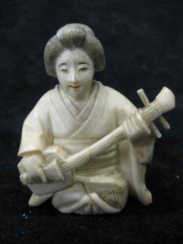 Appraisal: Carved Ivory Figurine of Seated Womanwith musical instrument polychrome trim