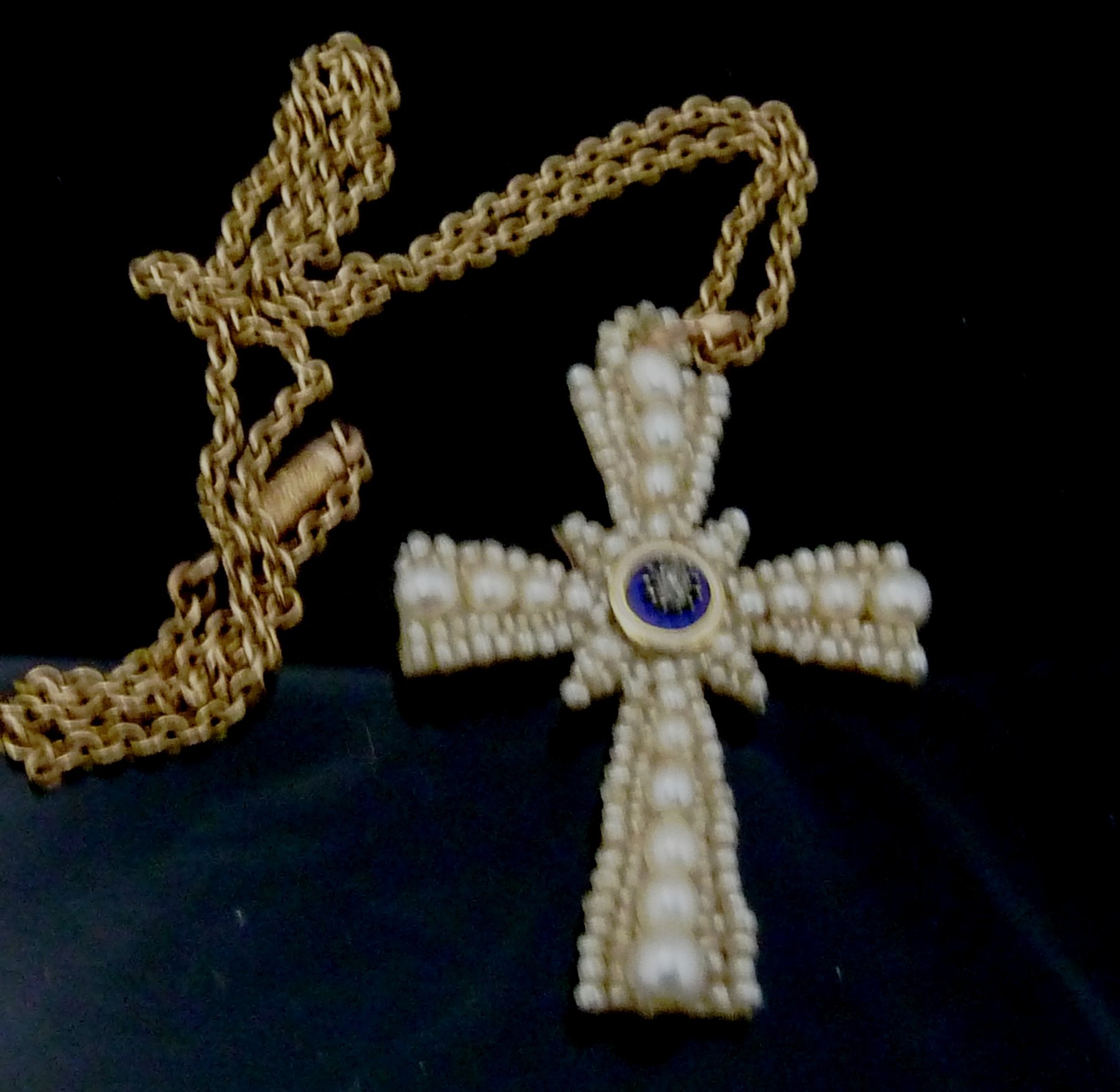 Appraisal: A pearl set cross centred by a small diamond on