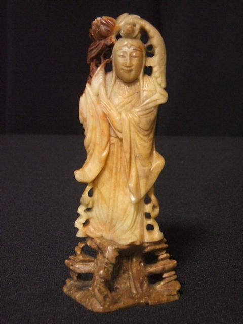 Appraisal: CHINESE SOAPSTONE MAIDEN She holds a lotus branch above a