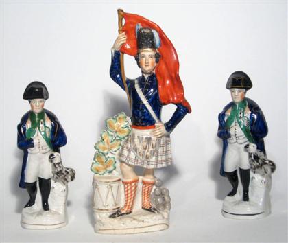 Appraisal: Staffordshire figure of a Scot with flag and two Napoleon