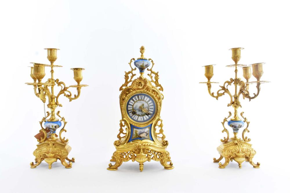 Appraisal: FRENCH PORCELAIN INSET GILT BRONZE CLOCK GARNITUREComprising two multi-light candelabra