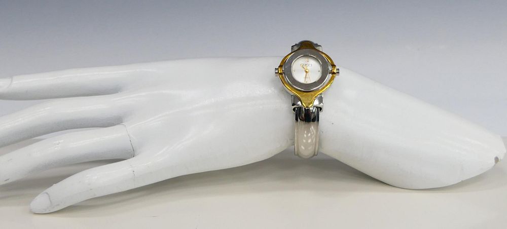 Appraisal: GUCCI LADIES STAINLESS ROTATING WATCH BRACELET Stainless with tone gold