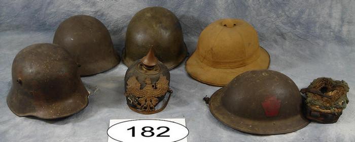 Appraisal: Group of four metal olive drab military helmets W W