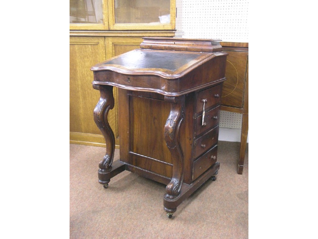 Appraisal: A Victorian walnut Davenport hinged stationery compartment above sloping top