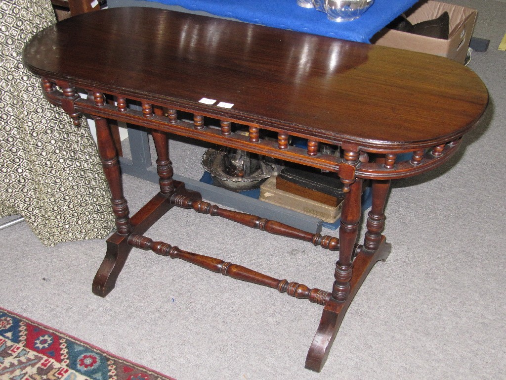 Appraisal: Mahogany occasional table with D ends and raised on spindle