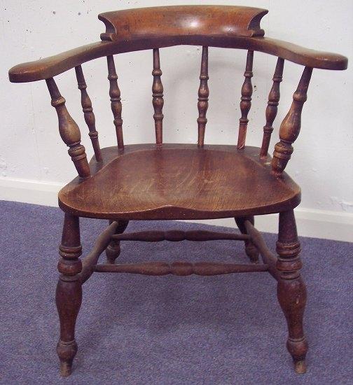 Appraisal: A smoker's elbow chair with dished elm seat on turned