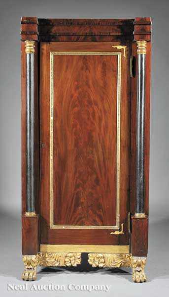 Appraisal: An American Classical Carved Mahogany Gilded and Ebonized Armoire early-to-mid