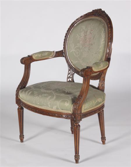 Appraisal: A mahogany framed fauteuil the cushioned oval back with ribbon