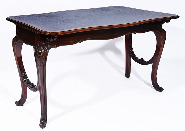 Appraisal: A FRENCH STYLE MAHOGANY LIBRARY TABLE with leather top on