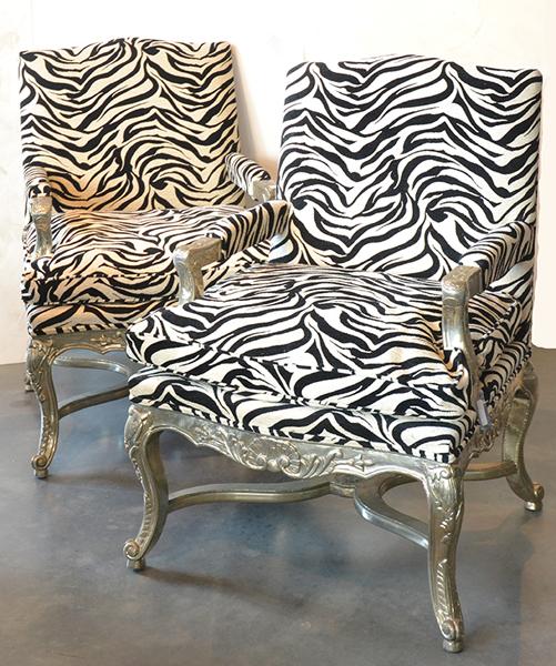 Appraisal: A PAIR OF REPOUSSE SILVER METAL ARMCHAIRS UPHOLSTERED IN BLACK