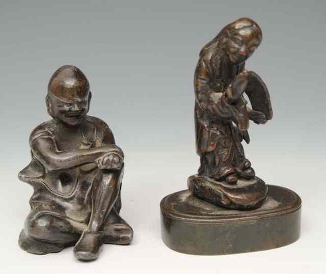 Appraisal: A CHINESE SMALL BRONZE MODEL of a figure reading from