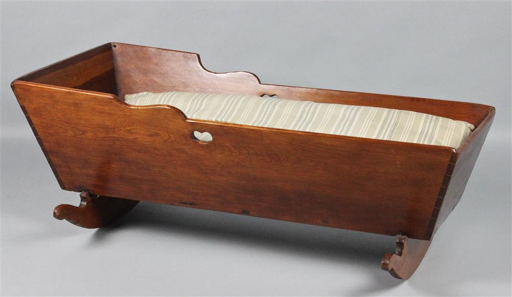 Appraisal: AMERICAN CHERRYWOOD CRADLE TH CENTURY having stepped and shaped sides