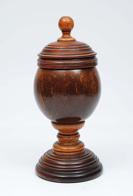 Appraisal: A COCONUT CUP with turned wooden cover and standing on