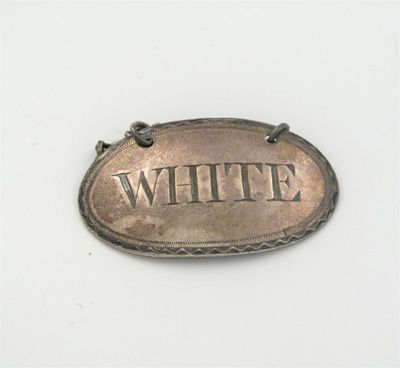 Appraisal: A George III bright-cut oval wine label incised 'WHITE' makers