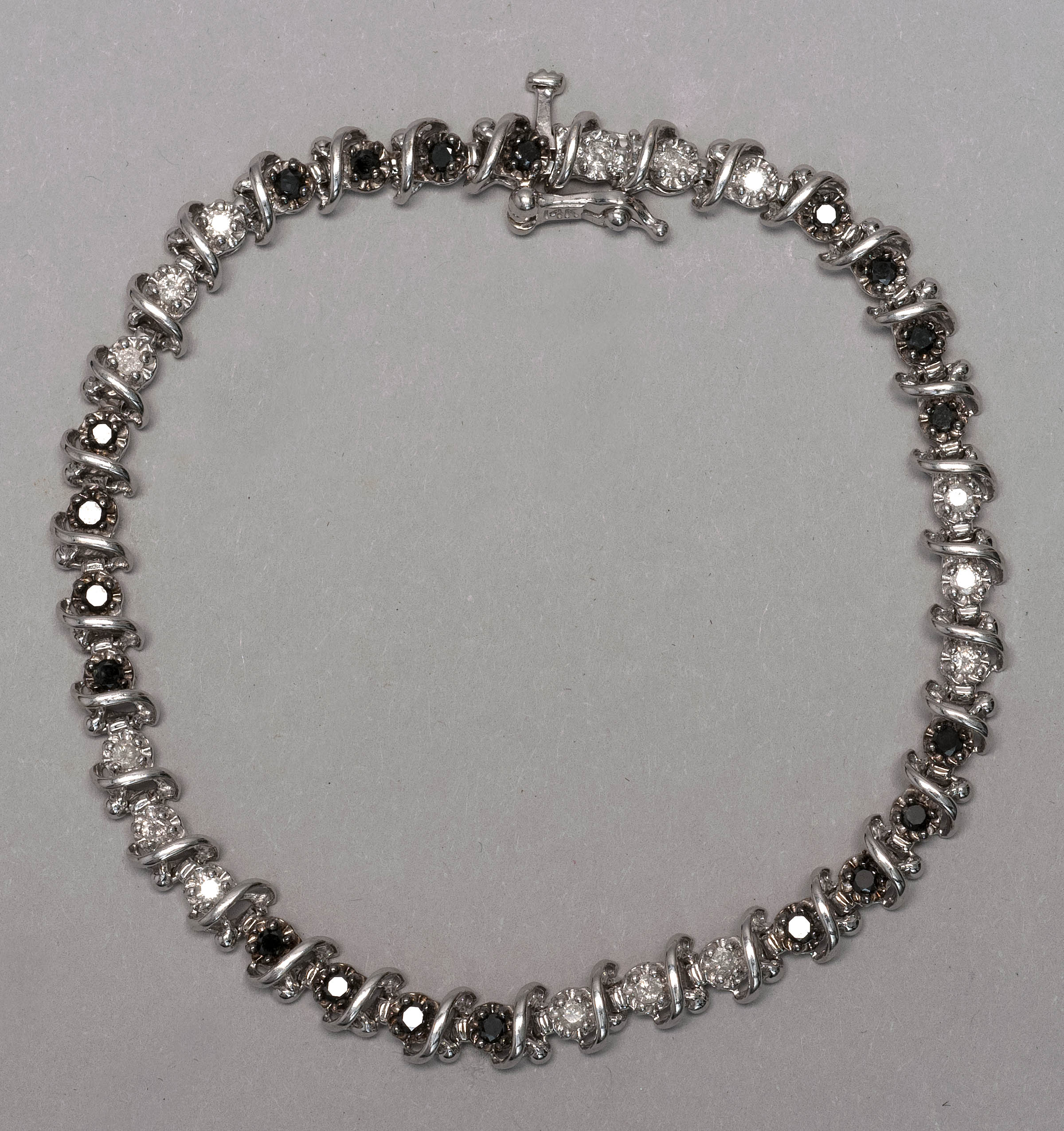 Appraisal: KT WHITE GOLD DIAMOND AND BLACK DIAMOND TENNIS BRACELET Late