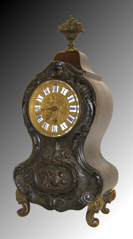 Appraisal: Mahogany and pressed horn balloon mantel timepiece the repousse brass