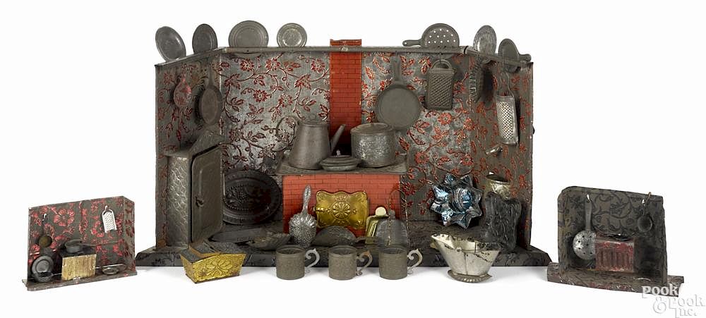 Appraisal: Three embossed tin kitchen play sets with various cooking accessories