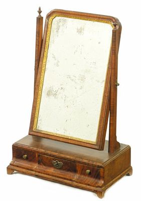 Appraisal: An early th century walnut dressing table mirror the bevelled