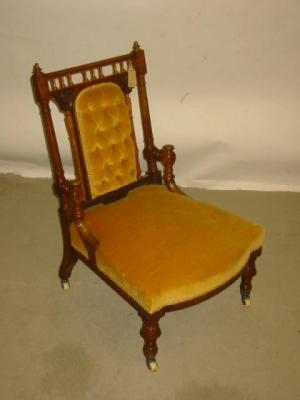 Appraisal: A VICTORIAN WALNUT NURSING CHAIR in the Aesthetic taste and