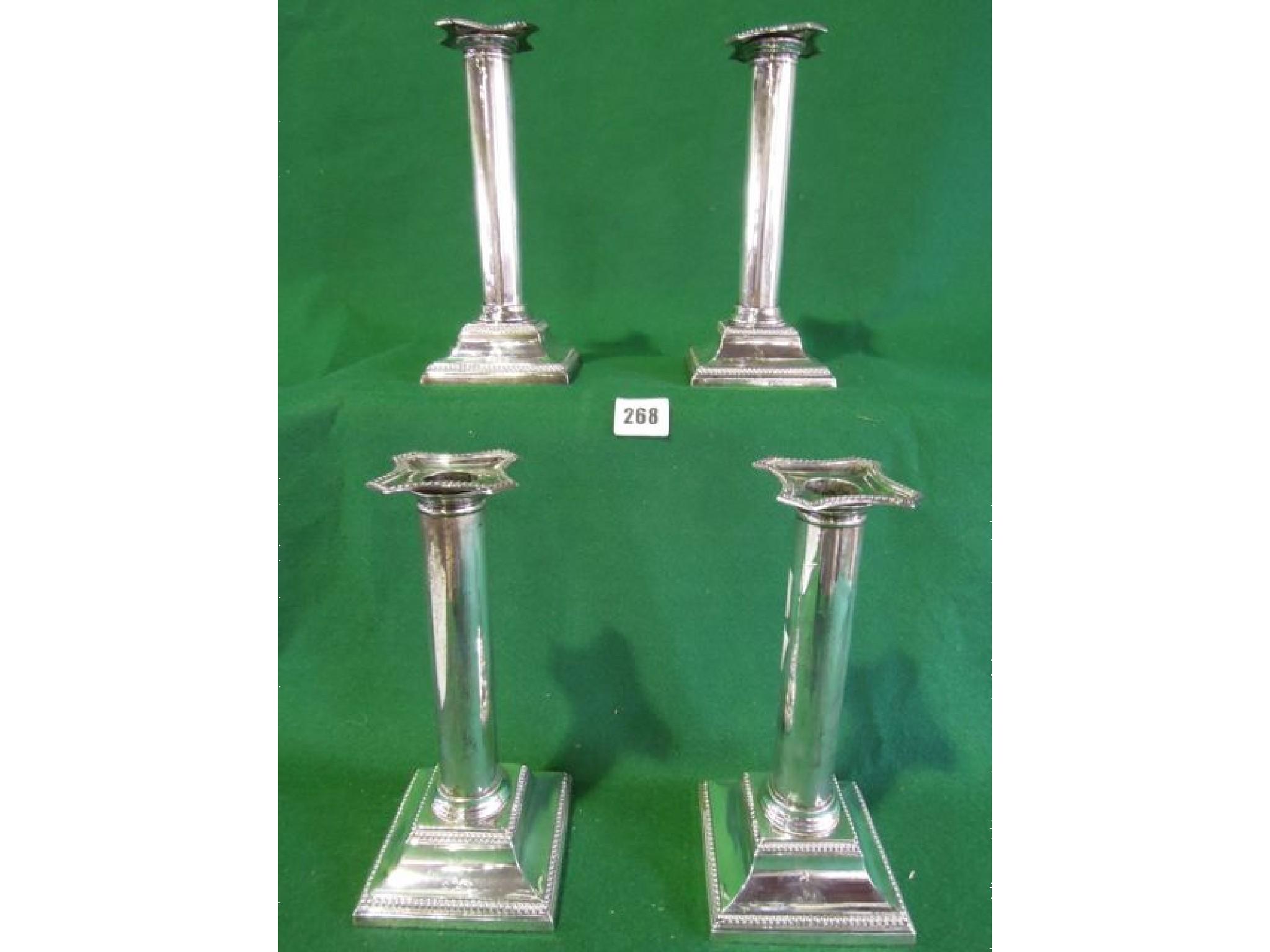 Appraisal: A set of four Edwardian candlesticks in the form of