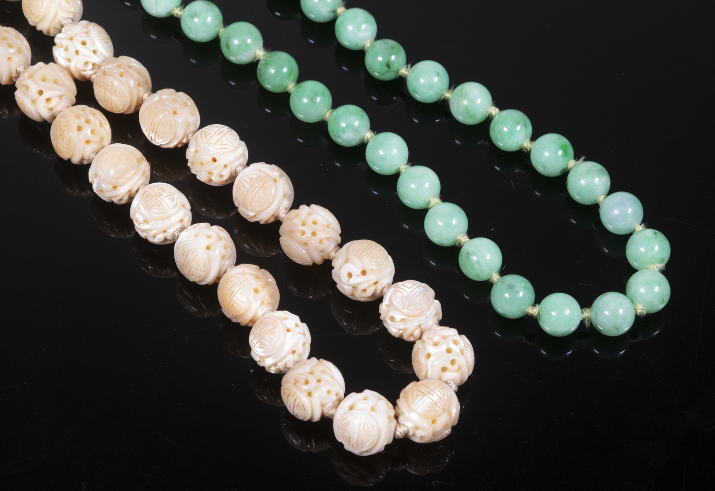 Appraisal: CHINESE NECKLACES Including Carved mother-of-pearl ball form necklace long and