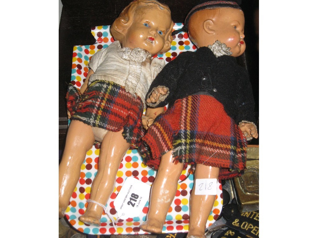 Appraisal: Pair of girl and boy dolls in Highland dress