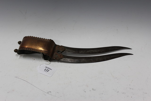 Appraisal: AN INDIAN STEEL BLADED BRONZE HANDLED BICHWA with loop hilt